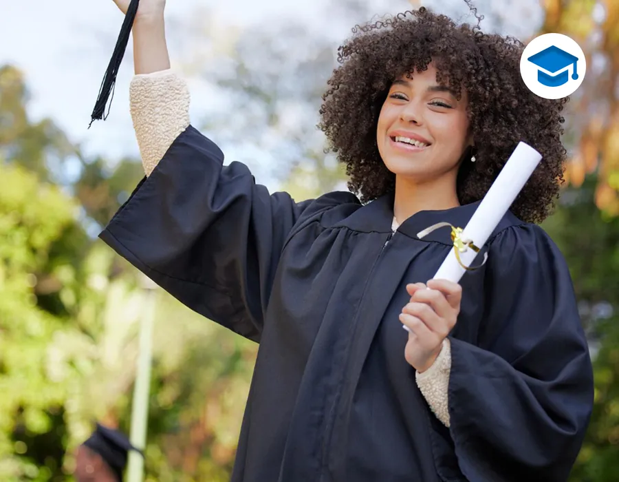 A graduate in cap and gown holding her diploma