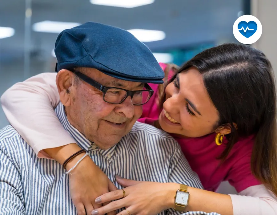 A grandfather being hugged by his granddaughter